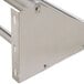 A stainless steel Advance Tabco wall mounted rack shelf with two tubular holes.
