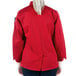 The back of a woman wearing a red Mercer Culinary Millennia long sleeve cook jacket.