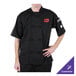 A man wearing a black Mercer Culinary chef coat.