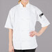 A woman wearing a white Mercer Culinary chef jacket.