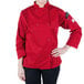 A woman wearing a red Mercer Culinary Millennia chef coat.