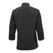 A Mercer Culinary Millennia black chef jacket with long cuffed sleeves.