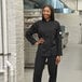 A woman in a black Mercer Culinary Millennia chef's coat.