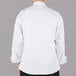 A person wearing a Mercer Culinary white long sleeve cook jacket.