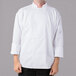 A man wearing a Mercer Culinary Millennia Air long sleeve white chef jacket with full mesh back.