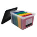 An Innovative Storage Designs clear plastic file tote with colorful files inside.