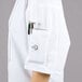 A person wearing a Mercer Culinary Millennia Air short sleeve cook jacket with full mesh back.