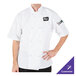 A man wearing a Mercer Culinary white chef jacket with cloth knot buttons.