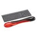 A red and black Kensington keyboard wrist rest with a mouse pad.