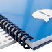 A blue Swingline ProClick binding spine in a spiral bound notebook with a blue cover.