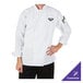 A chef wearing a Mercer Culinary Millennia white long sleeve cook jacket.