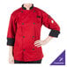A person wearing a red Mercer Culinary chef's coat.