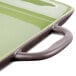 A close up of a green rectangular baking dish with handles.