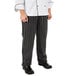 A person wearing Mercer Culinary black and white striped cook pants.