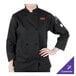 A woman wearing a black Mercer Culinary Millennia chef jacket with a cloth knot button.