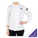 A woman wearing a white Mercer Culinary long sleeve chef jacket.