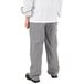 A person wearing a white shirt and Mercer Culinary Millennia houndstooth chef pants.