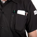 a person wearing a black shirt with a pocket full of tools
