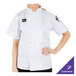 A woman wearing a white Mercer Culinary chef's coat.