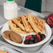 A Carlisle polycarbonate plate with waffles and fruit on a tray.