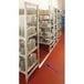 A white Cambro Camshelving® track with plates stacked on it.