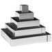 A silver metal square wedding cake frame.