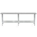 A long silver Advance Tabco stainless steel work table with metal legs and a galvanized undershelf.