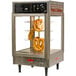 A Benchmark USA countertop food warmer with pretzels on a rack.