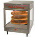 A Benchmark USA humidified pizza display warmer with a pizza on it.