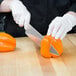 a person cutting a bell pepper with a knife