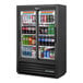 A True 36-inch black narrow convenience store merchandiser refrigerator with sliding glass doors full of drinks.