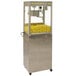 A Benchmark USA pedestal base with a popcorn machine on it filled with yellow popcorn.