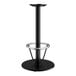 A Lancaster Table & Seating black cast iron bar height table base with a round foot ring.