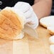 a person cutting bread with a knife