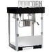 A Benchmark USA Metropolitan 6 oz. black and white popcorn machine.