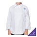 A Mercer Culinary Renaissance women's chef jacket with white fabric and royal blue piping on a person.