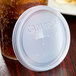 A plastic lid with a straw slot on a beverage container with text that reads "Cambro"