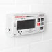 A white rectangular Cardinal Detecto digital scale with a screen on it.