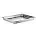 A silver rectangular Vollrath stainless steel steam table pan on a counter.