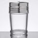 A clear glass American Metalcraft shaker with a stainless steel lid.