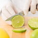 A person using a Mercer Culinary Z&#252;M&#174; forged paring knife to cut a lime.