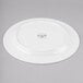A white Reserve by Libbey bone china dinner plate with a circular design on it.