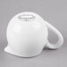 A white bone china creamer with a handle.