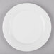 A white bone china dinner plate with a white rim.