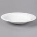 A white Reserve by Libbey bone china round soup bowl on a gray surface.