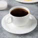 A Reserve by Libbey bone china stacking cup of coffee on a saucer.