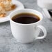 A Reserve by Libbey bone china coffee cup filled with coffee on a table.