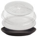 A clear plastic container with a black tray containing a stack of clear Cambro plates.