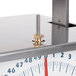 An Edlund metal scale with a bolt on top.