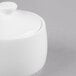 A white bone china sugar pot with a lid.